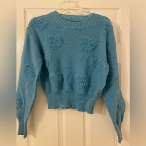 Blue knit sweater with hearts